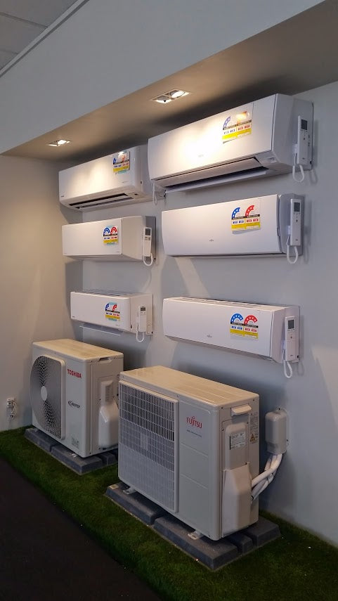 Split system air conditioner indoor and outdoor units on a display wall