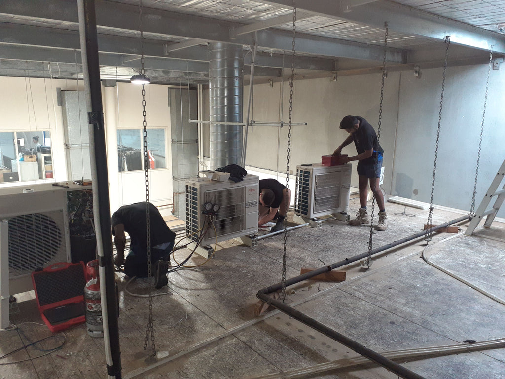 EZYAIR technicians installing outdoor air conditioning units in a commercial fit-out