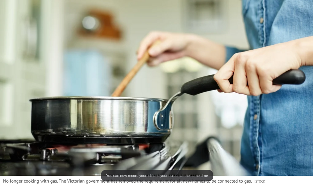 Person cooking with a saucepan on a gas stovetop