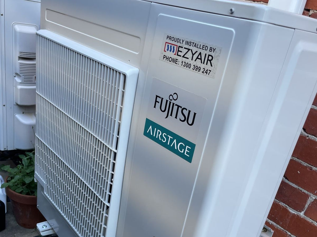 Fujitsu Airstage ducted reverse cycle outdoor unit installed by EZYAIR on a brick wall in Melbourne